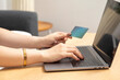 © bennnn - Woman shopping online , women relaxing at home and online shopping with laptop and pay with credit card.