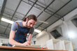 © FotoArtist - Carpenter working on the woodworking desk and furniture handmade with wood