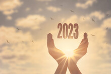 Hands Holding Of New Year 2023 Silhouette On Sunset Background
