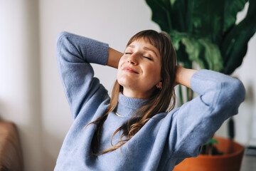 Wall Mural - Young businesswoman relaxing with her hands behind her head