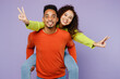 © ViDi Studio - Young cool couple two friends family man woman of African American ethnicity wear casual clothes together giving piggyback ride to joyful, sit on back isolated on pastel plain light purple background.