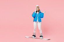 Snowboarder Woman Wearing Blue Suit Goggles Mask Hat Ski Padded Jacket Talk Speak On Mobile Cell Phone Isolated On Plain Pastel Pink Background. Winter Extreme Sport Hobby Weekend Trip Relax Concept.