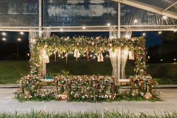 Wedding reception stage for husband and wife at the center, beautiful decoration and flower combination.