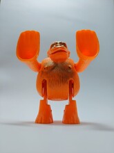 Close Up View Of Orange Gorilla Toys Made From Plastic Isolated On White Background.