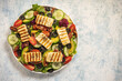 Greek style cuisine - salad with grilled halloumi cheese, avocado, pecan nuts and tomatoes.