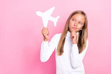 Sticker - Portrait of minded person hand touch chin hold paper plane brainstorming isolated on pink color background