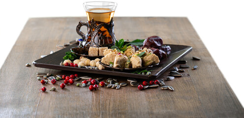 Wall Mural - Bronze plate with date fruits and tea on the background. Ramadan kareem.