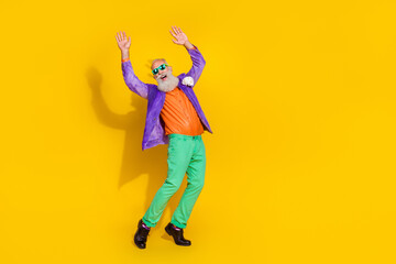 Sticker - Full length photo of excited cool guy dressed violet velvet jacket rising hands enjoying disco isolated yellow color background