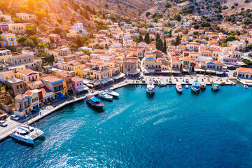 View on Symi (Simi) island harbor port, classical ship yachts, houses on island hills, Aegean Sea bay. Greece islands holidays vacation travel tours from Rhodos island. Symi, Greece,  Dodecanese.