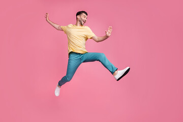 Canvas Print - Full length photo of crazy optimistic man sportsman participate sport contest champion look empty space isolated on pink color background