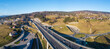 Poland. Zakopianka highway with newly opened tunnel in November 2022.  Multilevel spaghetti junction with traffic circles, viaducts, slip roads and traffic near Skomielna Biała. Aerial panorama