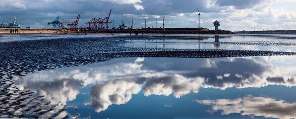 Canvas Print - Beautiful panoramic view of reflective water and construction site in a background