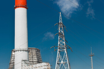 Wall Mural - The pipe of the industrial plant emits toxic smoke into the atmosphere and air. Pollution of the environment and ecology. Thermal power plant power lines high voltage