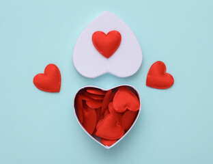 Wall Mural - White box with hearts on blue background. Love concept, valentine's day, february 14th celebration, top view