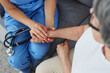 © Studio Romantic - Doctor giving compassion to patient. Young physician or cardiologist in blue scrubs, with stethoscope on lap sitting on couch and holding senior woman patient by hand. Support concept. Cropped shot