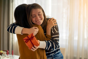 Two happy girls celebrate holiday, making nice gifts.