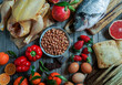 Allergy food concept. allergene - fish, chicken, strawberry, bread, wheat, sweet red pepper, eggs, peanuts, citrus, wheat flower and others on wooden table, top view