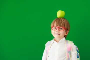 Poster - Happy child student against green chalkboard