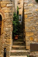 Poster - Narrow street between the old stone houses of ancient, historical town in the Volterra, Italy