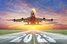 Inscription On The Runway 2023 Surface Of The Airport Road With Take Off Big Airplane. Concept Of Travel In The New Year, Holidays.