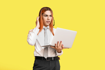 Poster - Beautiful transgender secretary in headset with laptop on yellow background