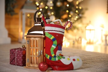 Sticker - Stocking, sweets, gift box and lantern on table. Saint Nicholas Day tradition