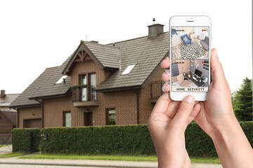 Wall Mural - Home security system. Woman monitoring CCTV cameras on smartphone near her house, closeup