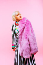 Portrait Of Senior Woman Against Colored Background