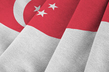 Singapore Flag With Big Folds Waving Close Up Under The Studio Light Indoors. The Official Symbols And Colors In Fabric Banner
