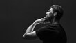 © USM Photography - Black and white portrait of attractive pensive young man looks into the distance stroking his beard. Side view portrait of thinking stylish young man touch his beard.