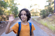 © zhukovvvlad - a boy with a backpack gives a high five. children's hike in the forest.