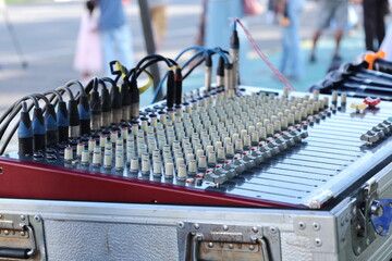 Button of the audio mic control. Close-up detail of equalizer mixer knobs or old fashioned audio mixer control panel at a concert or outdoor wedding with specific focus