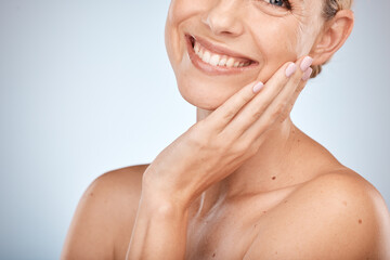 Face, beauty and skincare with a model woman in studio on a gray background with mockup for a natural product. Wellness, luxury and smile with a happy or attractive female posing to promote treatment