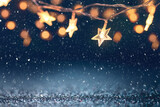 Defocus Christmas stars lights with falling snow, snowflakes, Winter and new year holidays. copy space.