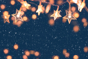 Wall Mural - defocus christmas stars lights with falling snow, snowflakes, winter and new year holidays. copy spa