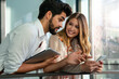 © NDABCREATIVITY - Happy businessman and woman with digital devices outdoors. Business people happiness concept