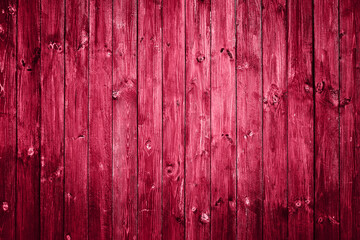 Vintage old wooden background colored in red viva magenta 2023. Abstract background. Top view