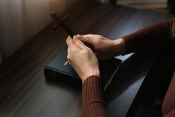 Women holds bible in hands. Reading the Holy Bible in home. Concept for faith, spirituality and religion. Peace, hope