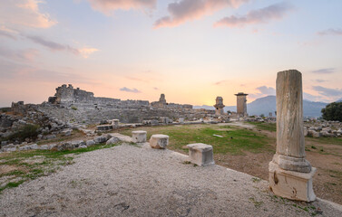 Wall Mural - Xanthos Ancient City. Grave monument and the ruins of ancient city of Xanthos - Letoon in Kas, Antalya, Turkey at sunset. Capital of Lycia.