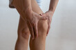 © Angelov - Physical injury of leg, knee, joint - woman holding painful part body.