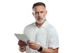 © Heyt/peopleimages.com - PNG studio portrait of a mature man looking confused while using a digital tablet against a grey background