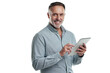 © Heyt/peopleimages.com - PNG studio portrait of a mature man using a digital tablet against a grey background