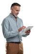 © Heyt/peopleimages.com - PNG studio shot of a mature man using a digital tablet against a grey background