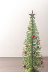 Wall Mural - Christmas tree with wooden background and copy space left,selective focus, Christmas concept