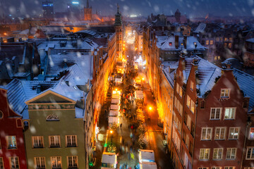 Wall Mural - Beautifully lit Christmas fair in the Main City of Gdansk during a snowfall. Poland