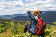 © Angelov - a woman rests after a hike in the mountains