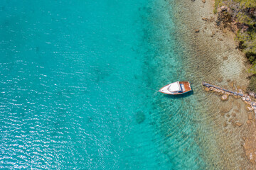 Wall Mural - Aerial view of a small leisure boat on the turquoise water of Mediterranean Sea