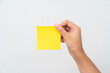 Women hand hold yellow adhesive note