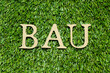 © bankrx - Wood alphabet letter in word BAU (abbreviation of business as usual) on green grass background