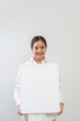 © littlestocker - Happy asian woman holding white board. Advertising copy space
